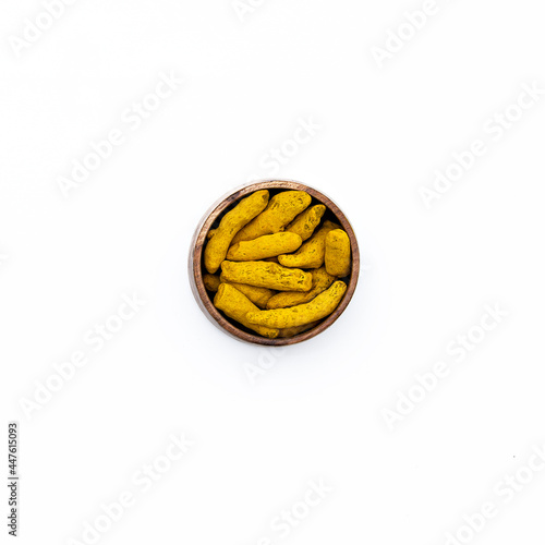 organic yellow curcuma or turmeric fingers or halkund on white background  photo