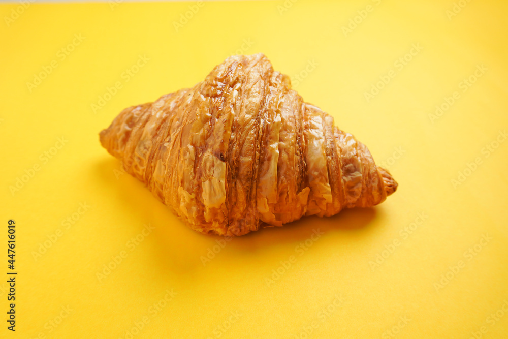 Croissant, on a yellow background, empty space, for breakfast, easy to supply before work.