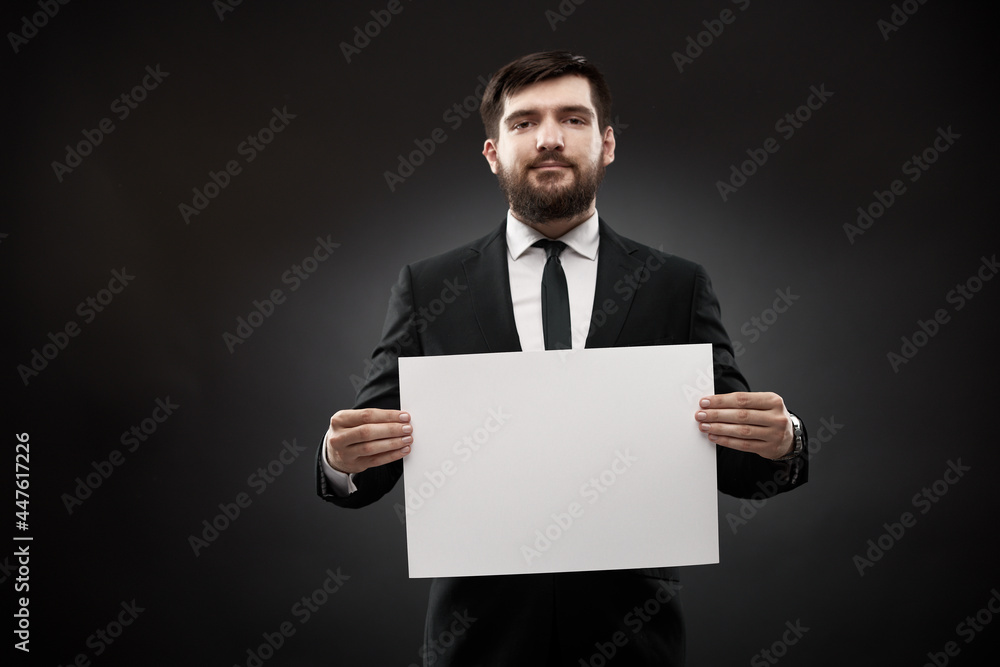 Businessman showing empty white paper Businessman showing empty white paper