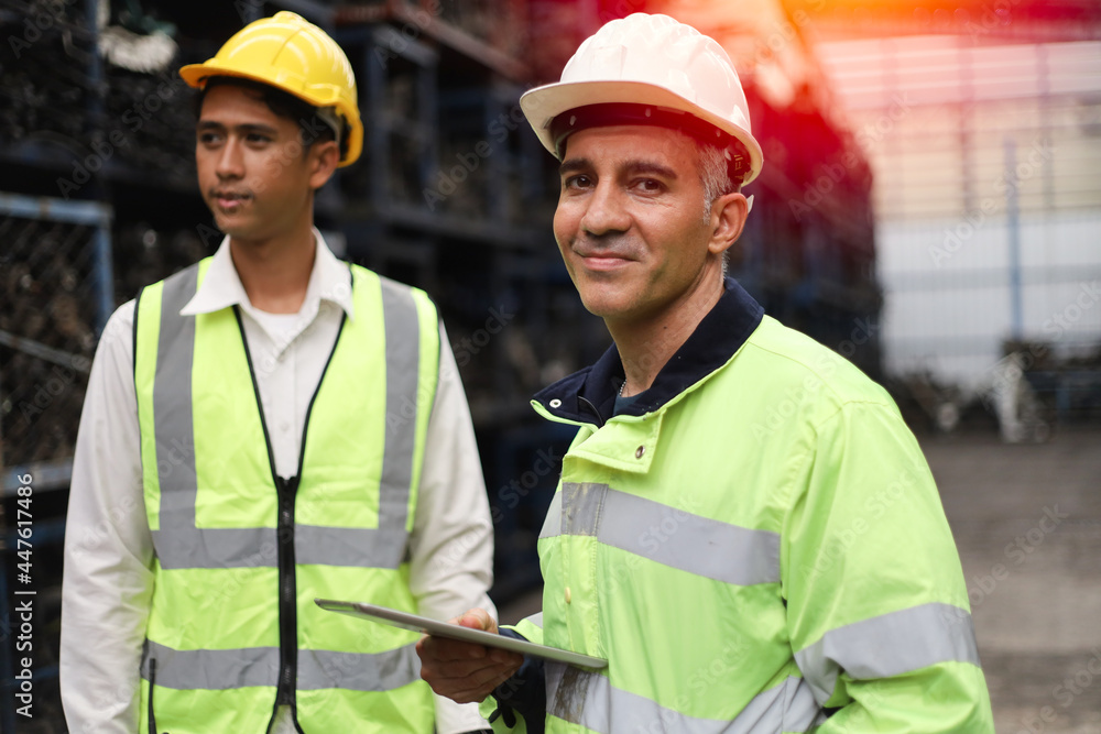 Worker or Engineer work in factory and talk with team, Check stock and inspection in machine spare part engine warehouse Worker or Engineer work in factory and talk with team, Check stock and inspection in machine spare part engine warehouse