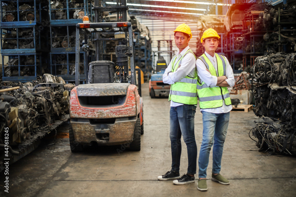 Worker or Engineer work in factory and talk with team by radio, Check stock and inspection in machine spare part of forklift engine in warehouse Worker or Engineer work in factory and talk with team by radio, Check stock and inspection in machine spare part of forklift engine in warehouse