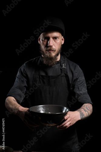 Chef holding a bowl with freshly made soup