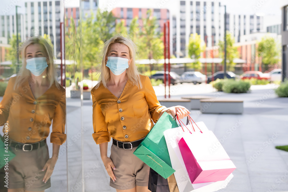 Young woman with face mask shopping during virus pandemic