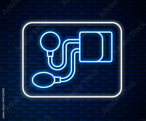 Glowing neon line Blood pressure icon isolated on brick wall background. Vector