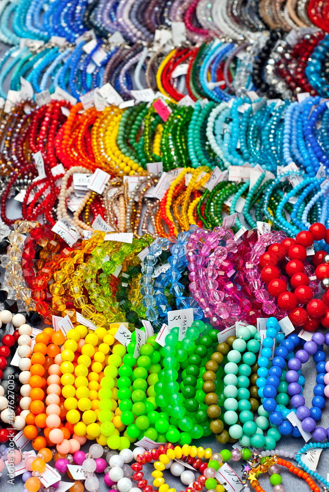 Necklace of colorful stones on the table. Many different jewelry and beads made of natural precious minerals. Beaded jewelry is on sale at the fair.