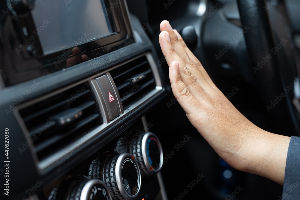 woman adjusting the cooling inside her car woman adjusting the cooling inside her car
