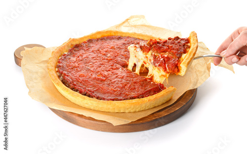 Woman taking piece of tasty Chicago-style pizza on white background