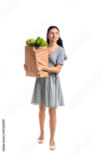 Young woman holding paper b...