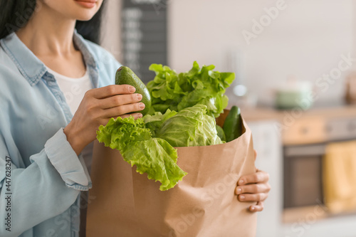 Young woman holding paper b...