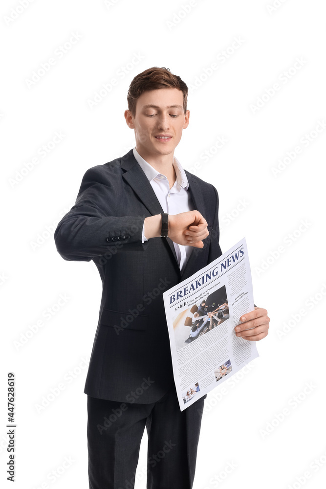 Young businessman with newspaper looking at wristwatch on white background Young businessman with newspaper looking at wristwatch on white background