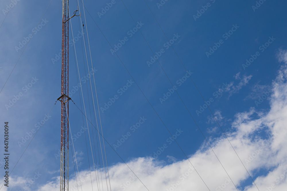 radio transmission towers in the city behind the bright sky radio transmission towers in the city behind the bright sky