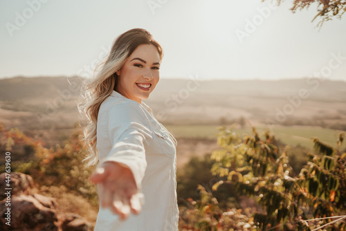 Billede på lærred Latin woman reaching out to camera, inviting to a trip