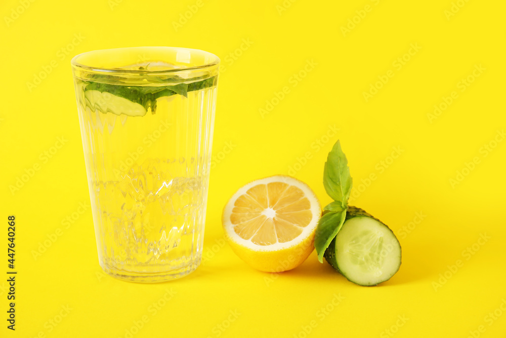 Glass with cucumber lemonade on color background Glass with cucumber lemonade on color background