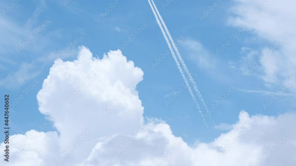 Passenger airplane at cruising altitude with contrail against blue sky. Passenger airplane at cruising altitude with contrail against blue sky.