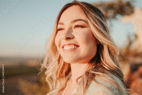 Beautiful young blond Latin woman outdoors portrait. Hair develop on a wind. Fashion concept.