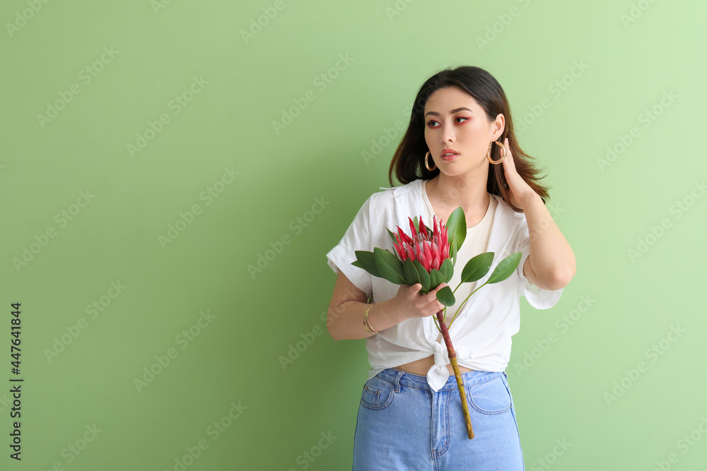 Beautiful young woman with protea flower on color background Beautiful young woman with protea flower on color background