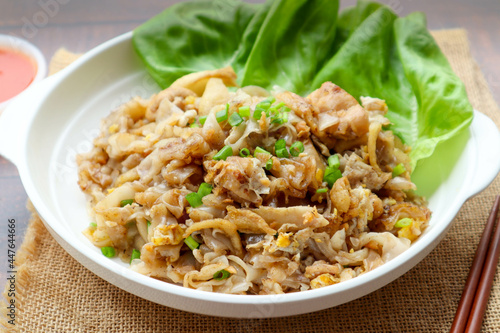 Stir fried rice noodles with chicken - Thai food called Kuay Teow Kua Gai at close up view