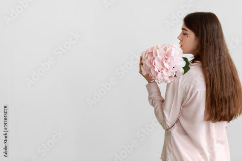 Young woman with hydrangea ...
