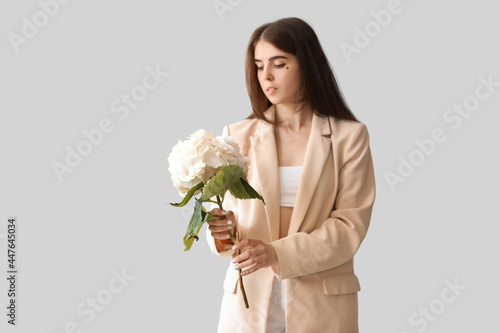 Young woman with hydrangea ...