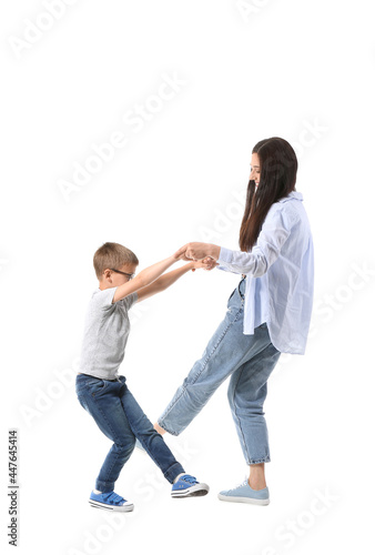 Dancing young woman and her little son on white background
