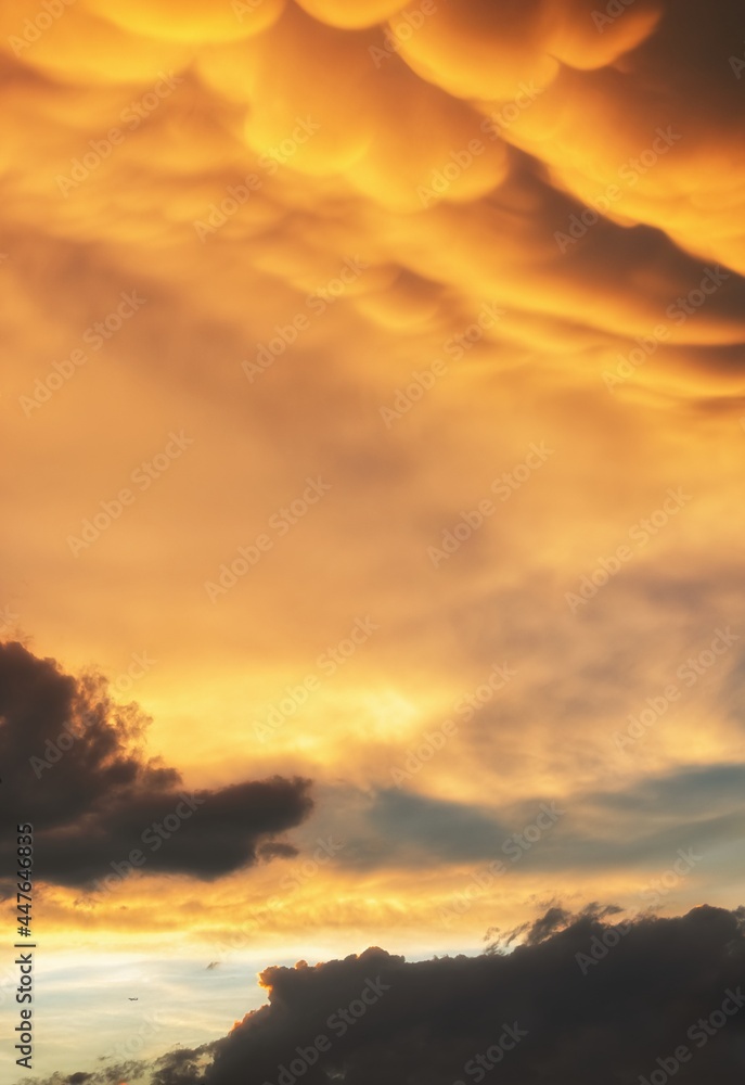 Dramatic sunset sky background with mammatus clouds Dramatic sunset sky background with mammatus clouds