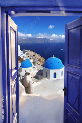 Santorini view with churches against blue sky in Oia village, Greece