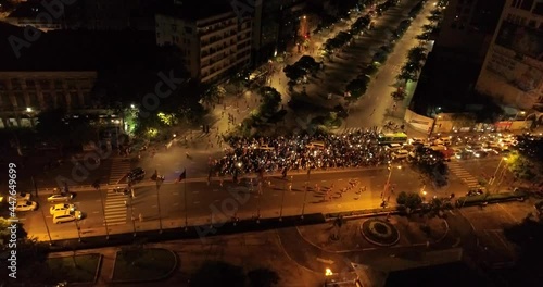 Aerial shot of many runners running on the street at night of Ho Chi Minh City, Vietnam photo