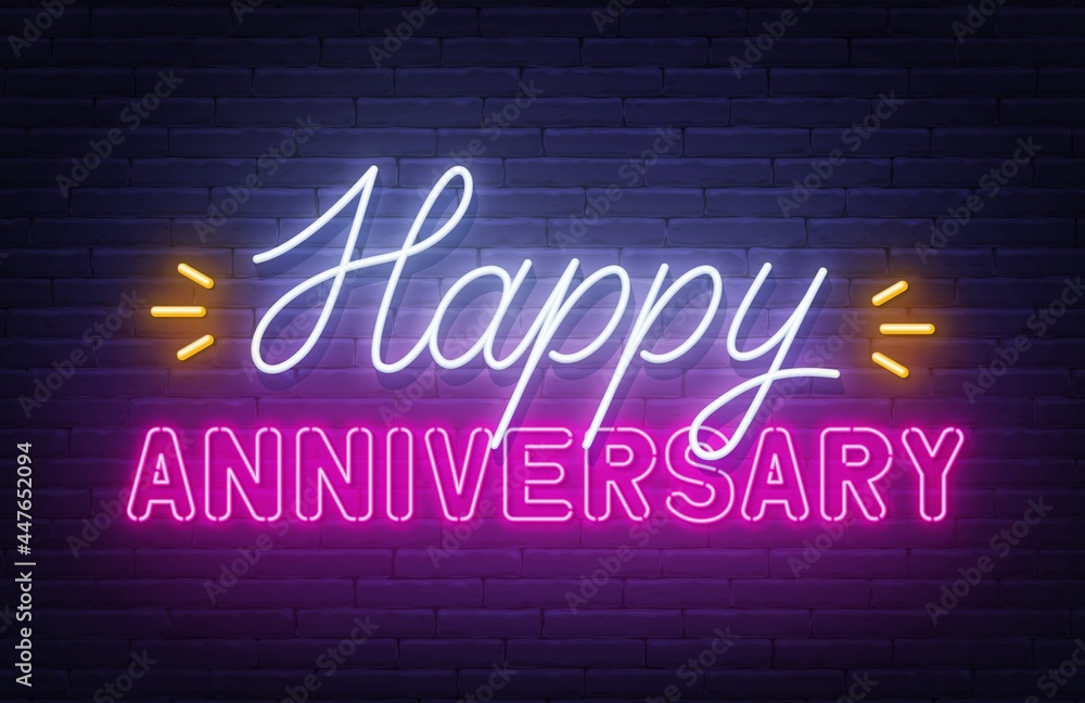 Happy anniversary neon text. Greeting card on brick wall background. Happy anniversary neon text. Greeting card on brick wall background.