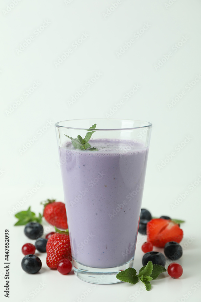 Glass of smoothie and ingredients on white background Glass of smoothie and ingredients on white background