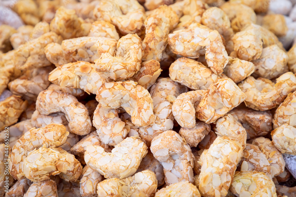 Traditional Italian cookies made from almond flour (Amaretti) covered with powdered sugar Traditional Italian cookies made from almond flour (Amaretti) covered with powdered sugar