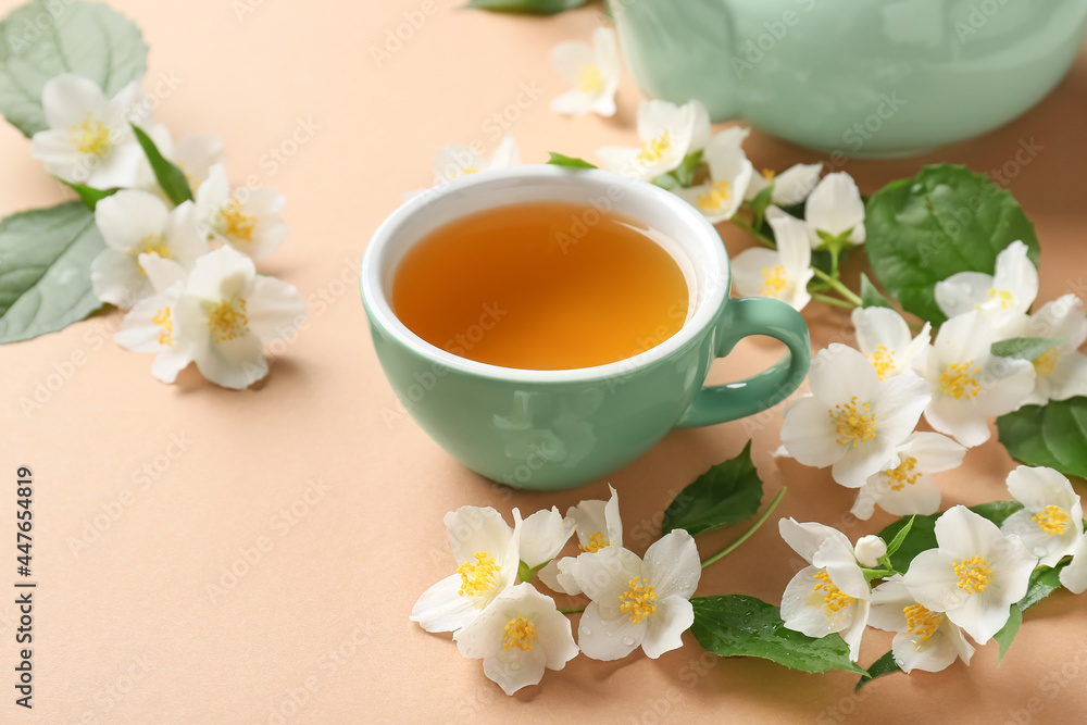 Cup of jasmine tea and flowers on color background Cup of jasmine tea and flowers on color background