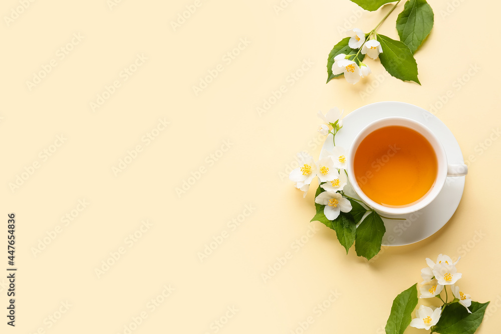 Cup of jasmine tea and flowers on color background Stock Photo | Adobe