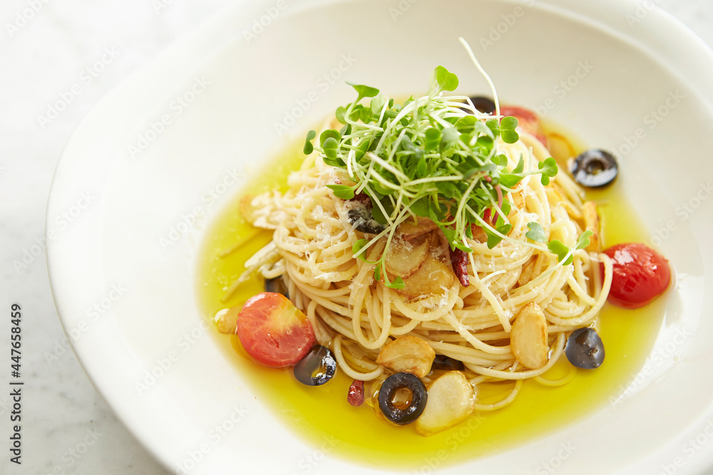 Oil tomato vegetable pasta on plate 