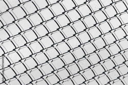 Fence cage Rabitz covers gray concrete wall