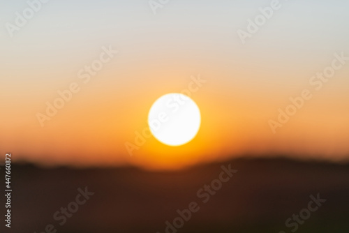 Blurred sunset landscape.Summer holiday concept. blurry beautiful sunlight and golden sunset background.