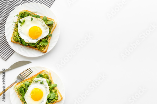 Sandwich with eggs avocado cream and spinach, top view