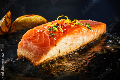Gourmet salmon fillet grilling on a griddle in close up photo
