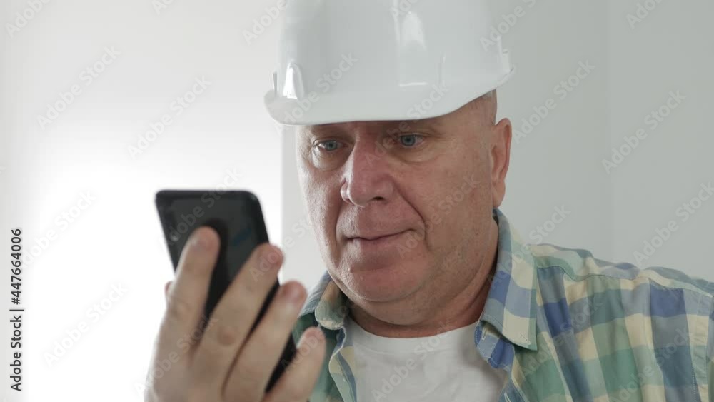 Engineer Text on Mobile Phone. Constructor Sending and Receiving Emails on Cellphone. Engineer Text on Mobile Phone. Constructor Sending and Receiving Emails on Cellphone.