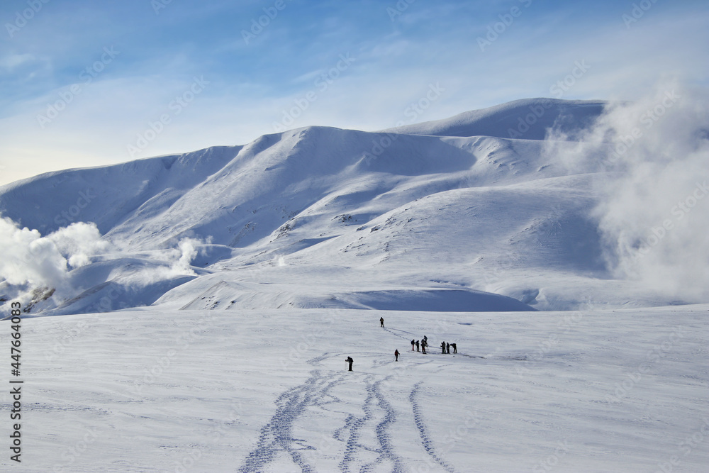 people hiking in the winter landscape of iceland