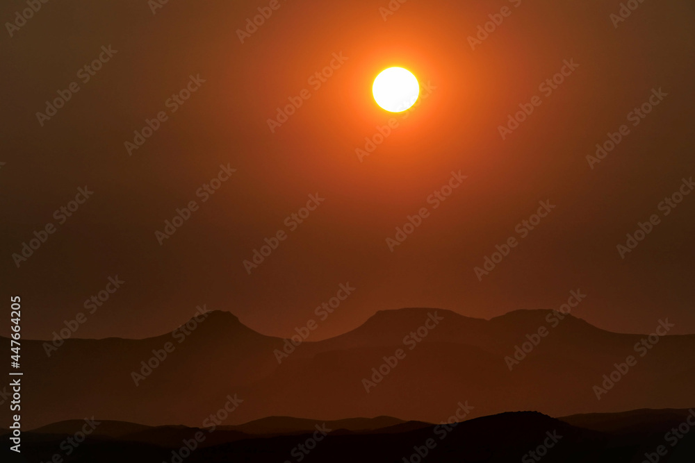 incredible view of setting sun above mountains in africa during sunset, red sky incredible view of setting sun above mountains in africa during sunset, red sky