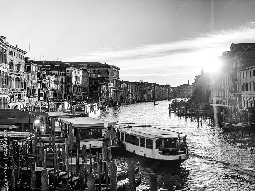 Black and white view of the grand canal from the Rialto Bridge at the sunset
