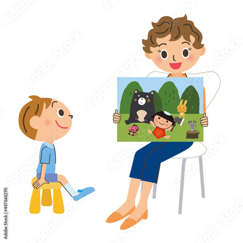 紙芝居を読み聞かせる先生と男の子