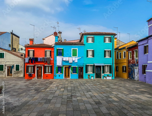 Colorful houses on a small traditional square at Burano island, Venice, Italy