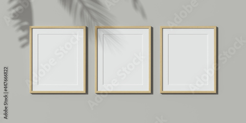 Fototapeta Three wooden frames on white wall