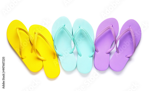 Set of stylish flip-flops on white background