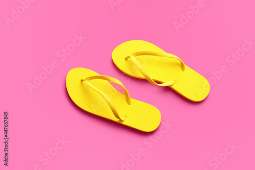 Stylish flip-flops on color background