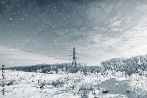 Long lines of power line towers stretching across a Winter Landscape.