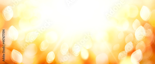 A golden sunny autumn thanksgiving sunset sky with blurred bokeh foliage background.