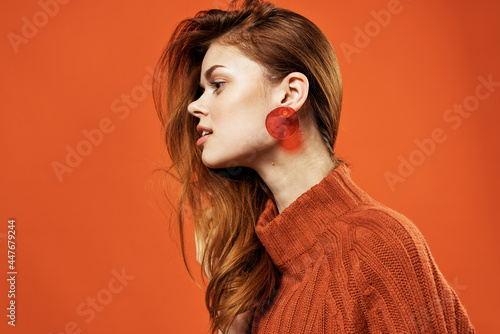 woman with red hair red sweater earrings jewelry model