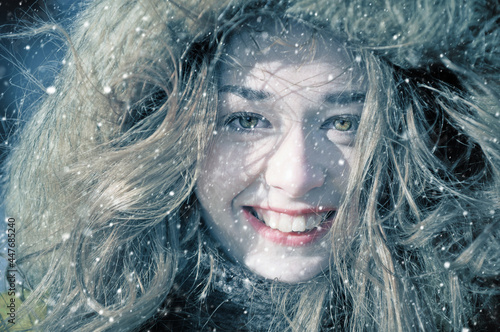 Beautiful young woman in a winter snow day